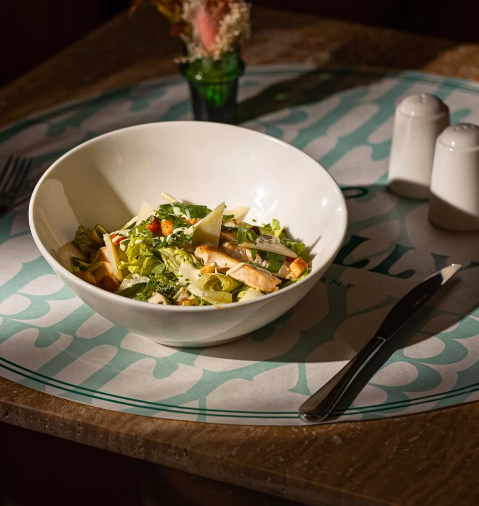 Chicken Caesar salad with parmesan and croutons on a Lily Billy placemat in Gueliz, Marrakech