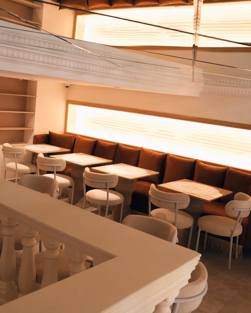 Rust velvet banquette and white bouclé chairs in the calm brunch room at Lily Billy, Gueliz Marrakech